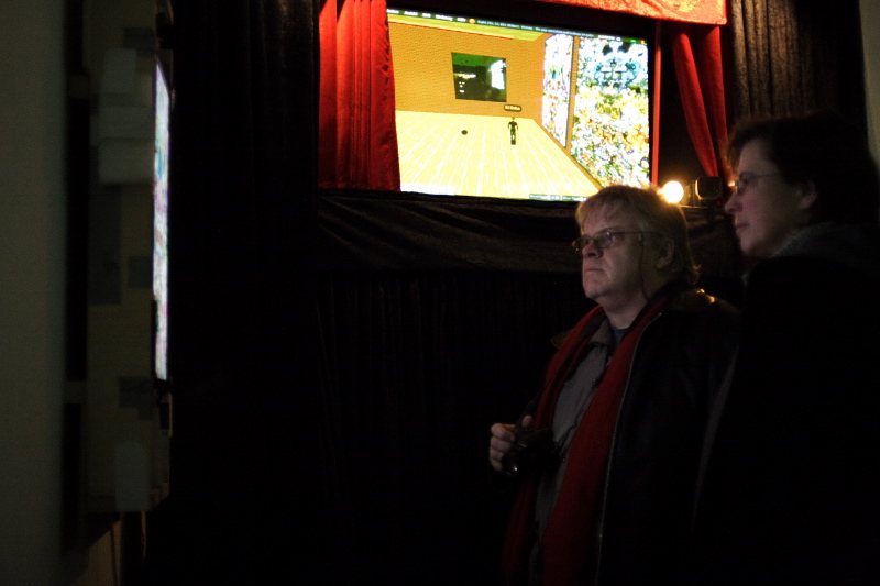 The audience watching the Second Life projection behind the red curtain