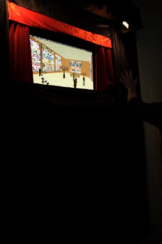 A collage on screen behind a red theatre curtain at the Blaues Haus