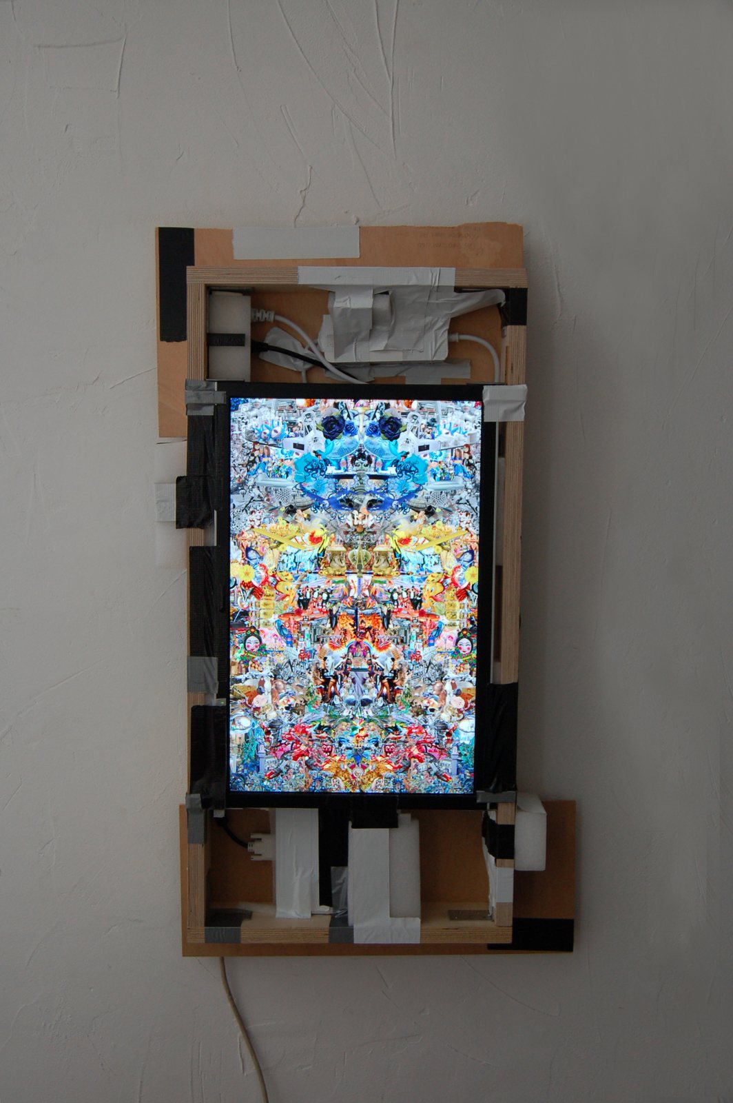 A collage held in a digital frame on the wall
