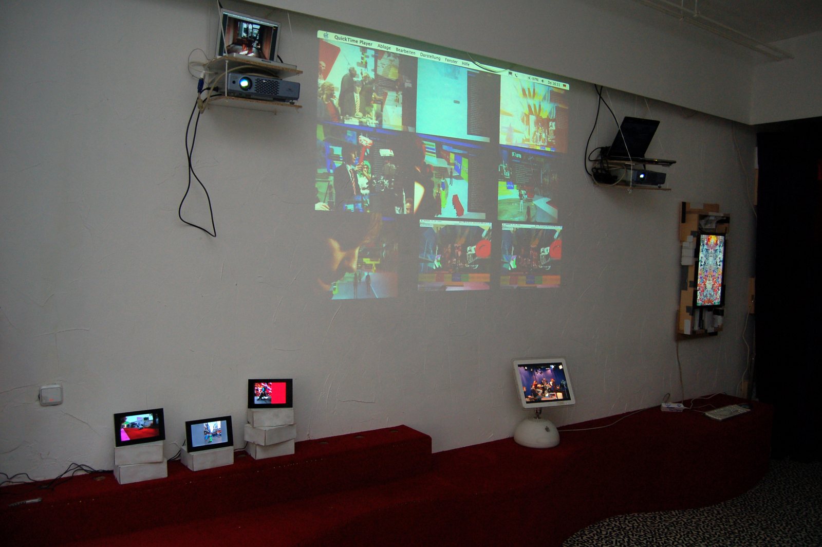 Wide view of the installation — screens, projections and frames
