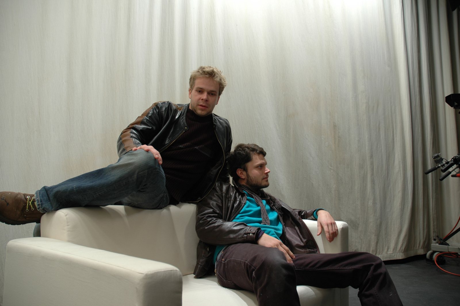 The studio plate — two models on a white couch against the backdrop